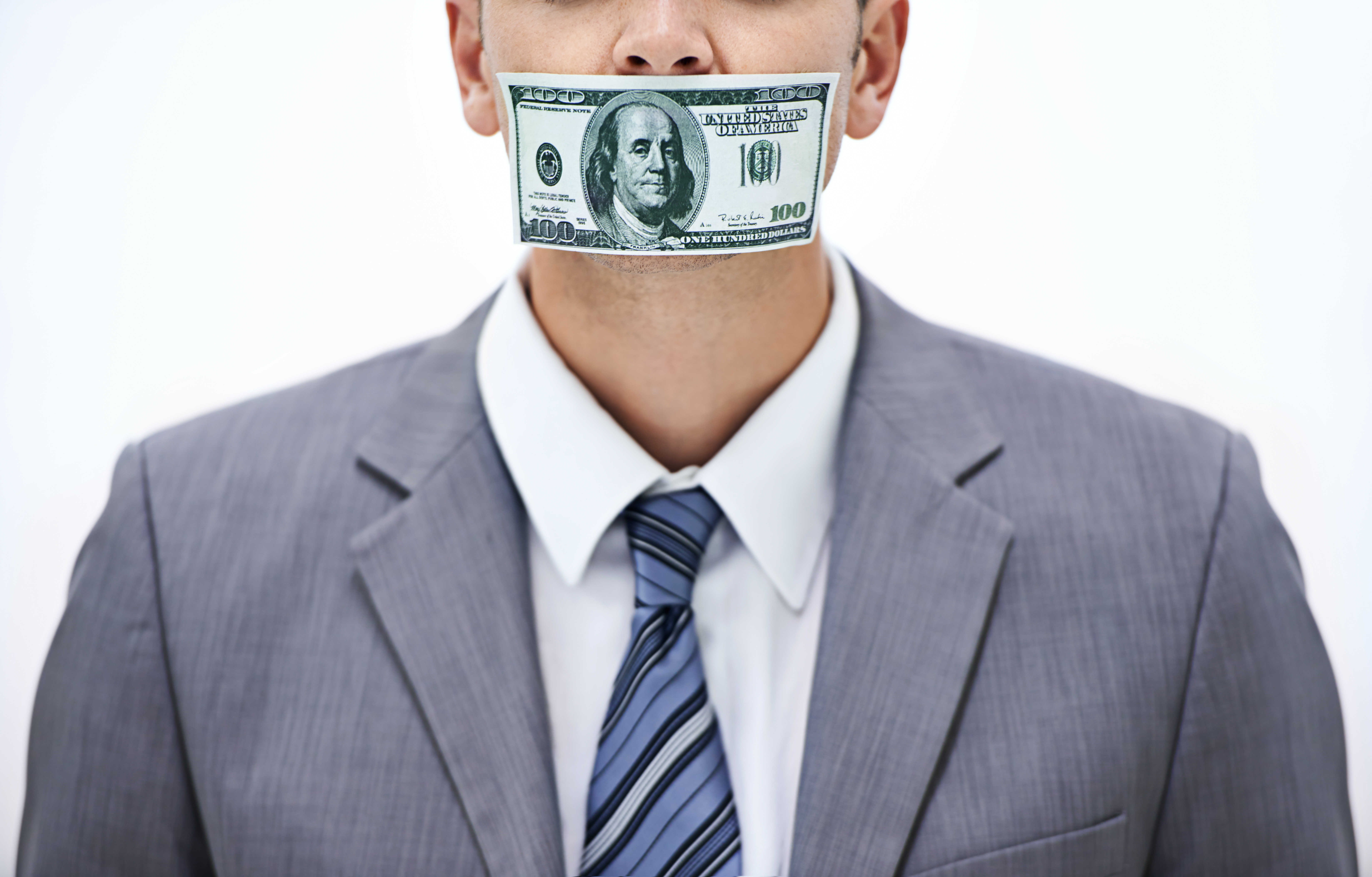 Concept shot of a businessman with money covering his mouth